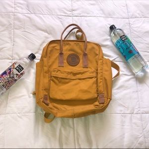 Yellow kanken backpack with leather detailing